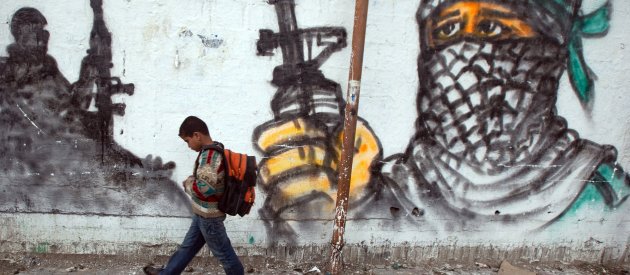 Palestinian boy passing by a grafitti as he walks to school at Jabalia area, northern Gaza Strip Palestinian boy passing by a grafitti as he walks to school at Jabalia area, northern Gaza Strip