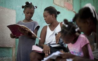 Nadege Auguste teaches her daughters at home. Access to education is a huge challenge in Haiti