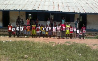 Pupils at the Activista Free Holiday Coaching Lesson in Tionsha community in Benue State Nigeria taking action as part of the Tax Power Campaign 
