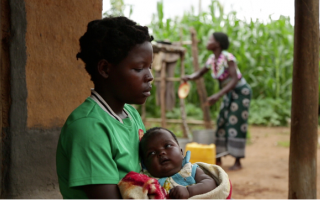 A 14-year-old girl holds her baby at her sister’s home in a village in Kanduku, in Malawi’s Mwanza district. She married in September 2013, but her husband chased her away. Her 15-year-old sister, in the background, married when she was 12. Both sisters s