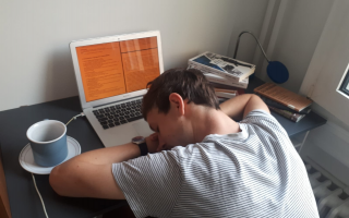 Student sleeping on laptop at desk
