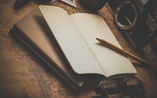 brown pencil on white notebook