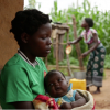 A 14-year-old girl holds her baby at her sister’s home in a village in Kanduku, in Malawi’s Mwanza district. She married in September 2013, but her husband chased her away. Her 15-year-old sister, in the background, married when she was 12. Both sisters s